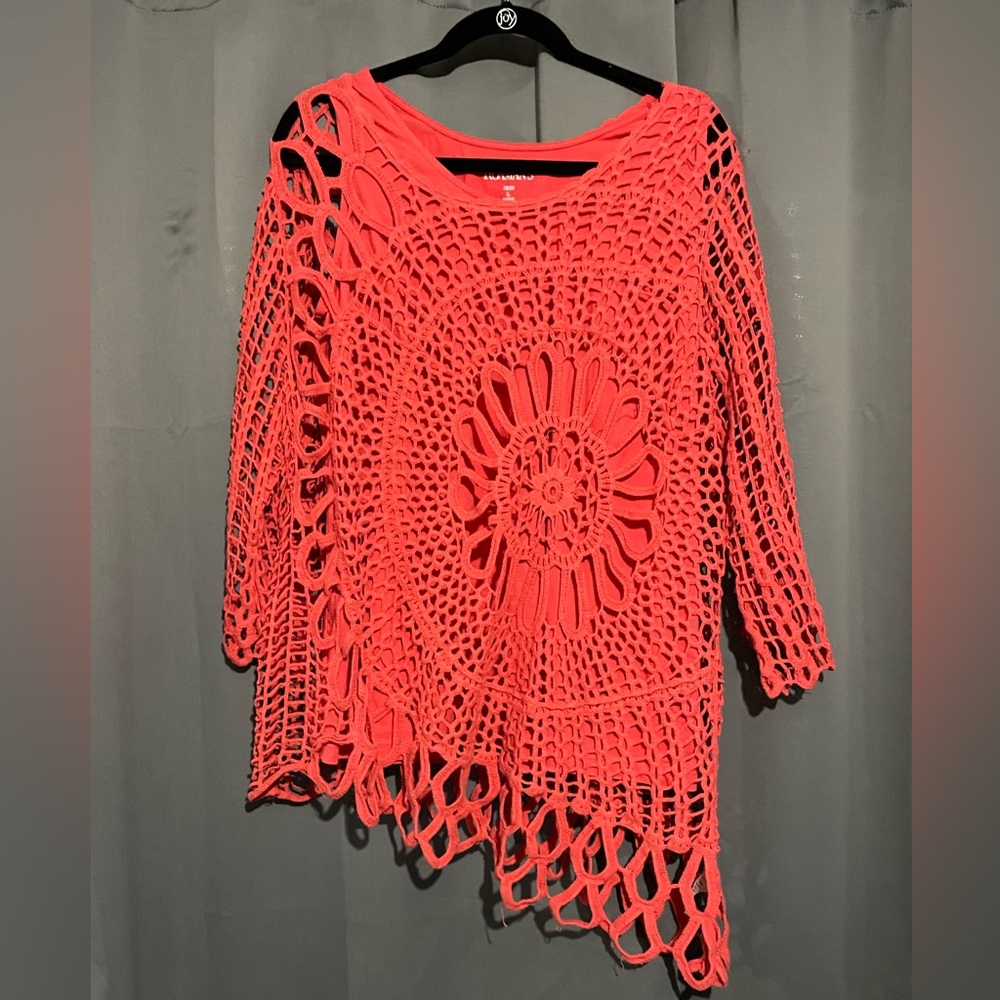 Coral pink crochet style overlay with same color undershirt.